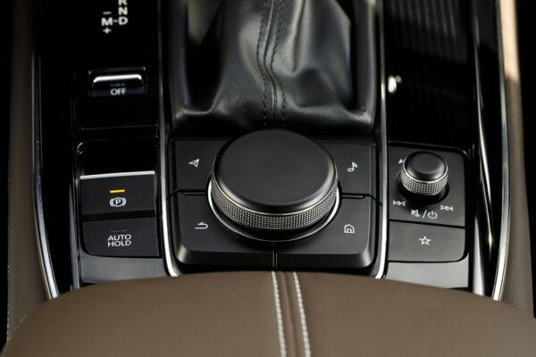 Center console control panel with dials and buttons. (Courtesy of Mazda)