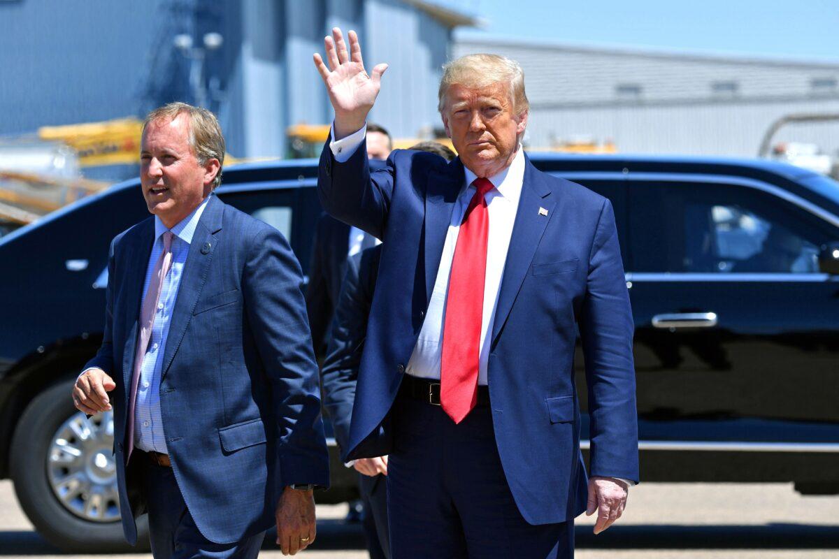 President Donald Trump waves upon arrival, alongside Attorney General of Texas Ken Paxton (L) in Dallas on June 11, 2020. (Nicholas Kamm/AFP via Getty Images)