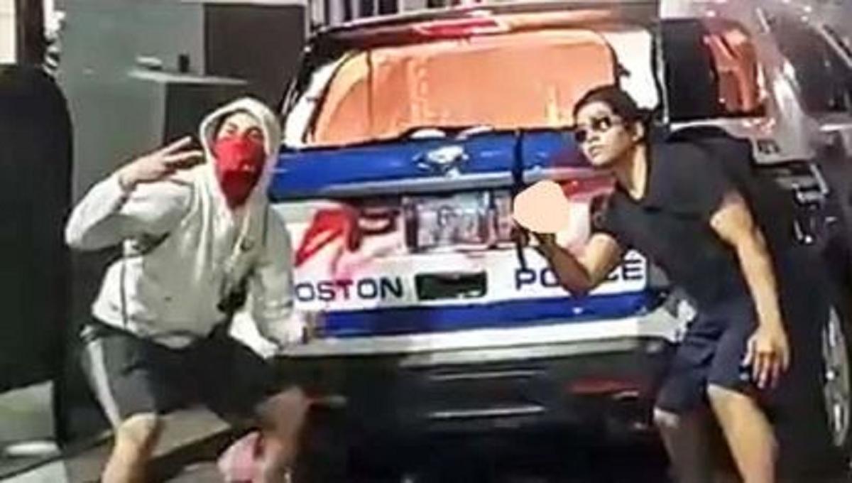 15-Year-Old Arrested After Photographs Showed Males Posing With Torched Police Car