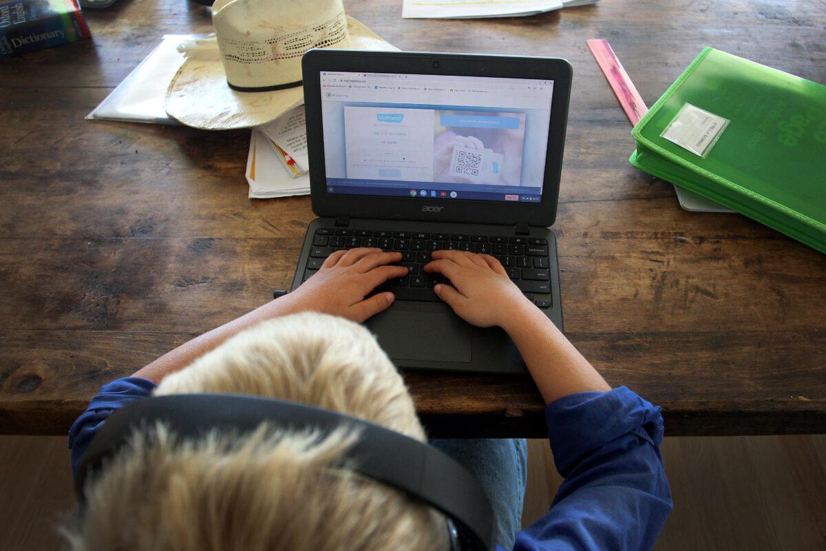 A Child doing his schoolwork at his family home in Tarpoly Creek, Australia, on April 5, 2020. (Lisa Maree Williams/Getty Images)