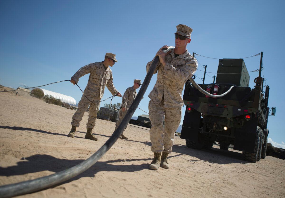 U.S. Marine Corps Cpl. Hunter, Jake, a radar technician, pulls the generator power cable to the Ground/Air Task Oriented Radar (G/ATOR) at Cannon Air Defense Complex (P111), in Yuma, Arizona, on Sept. 16, 2015. (U.S. Marine Corps photo by Cpl. Summer Dowding, MAWTS-1 COMCAM/Released)