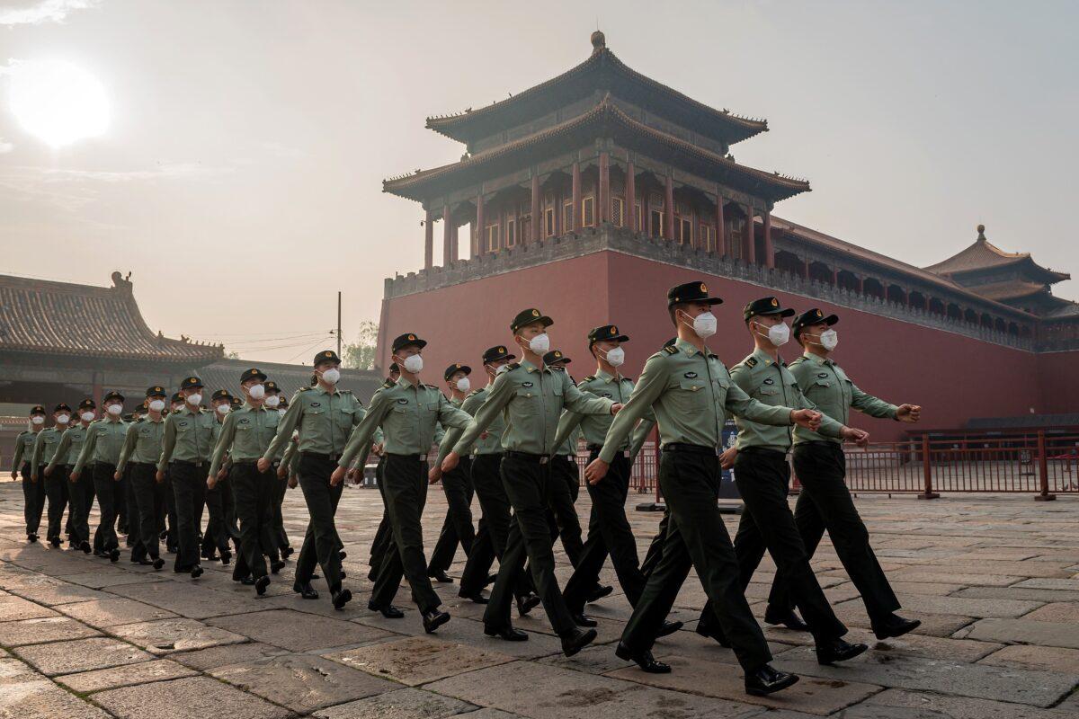 People's Liberation Army soldiers march next to the entrance to the Forbidden City on May 21, 2020, the day before the beginning of the two-week National People's Congress. (Nicolas Asfouri/AFP via Getty Images)