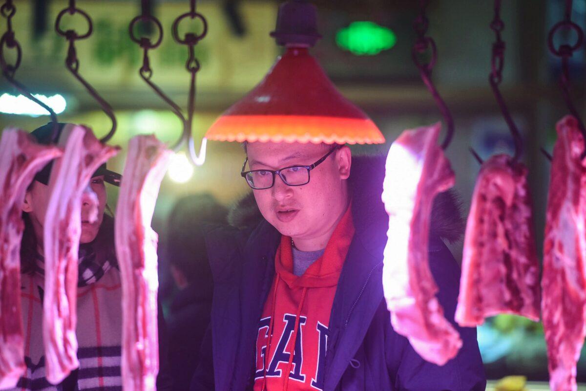 A customer looks at pork on sale at a market in Hangzhou city in China's eastern Zhejiang Province on Jan. 9, 2020. (AFP via Getty Images)