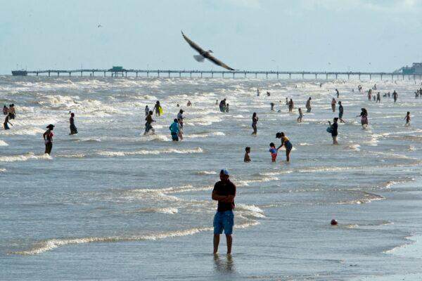 Beachgoers enjoy a day of sunshine at Galveston Beach in Galveston, Texas, on May 2, 2020. (Mark Felix/AFP via Getty Images)
