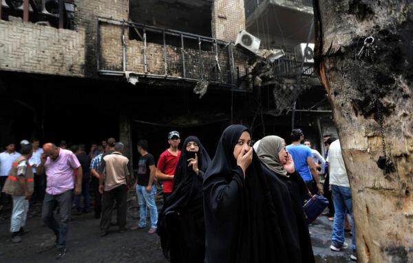 Iraqi women wait to hear about family members who went missing after a bomb hit Karradah, a busy shopping district in the center of Baghdad, Iraq, on July 3, 2016. (Hadi Mizban/AP Photo)