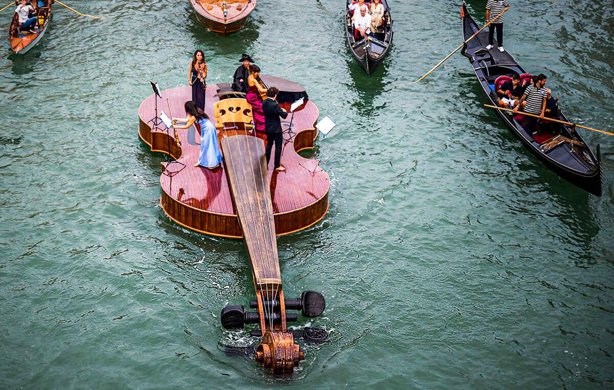 Sculptor in Venice Creates Giant 12-Meter-Long Violin That Floats Through Grand Canal