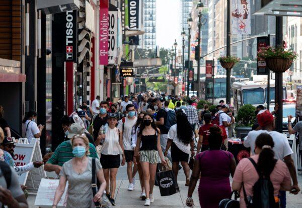 People walk through a shopping area in Manhattan in New York City on Jun. 7, 2021. (ANGELA WEISS/Getty Images)