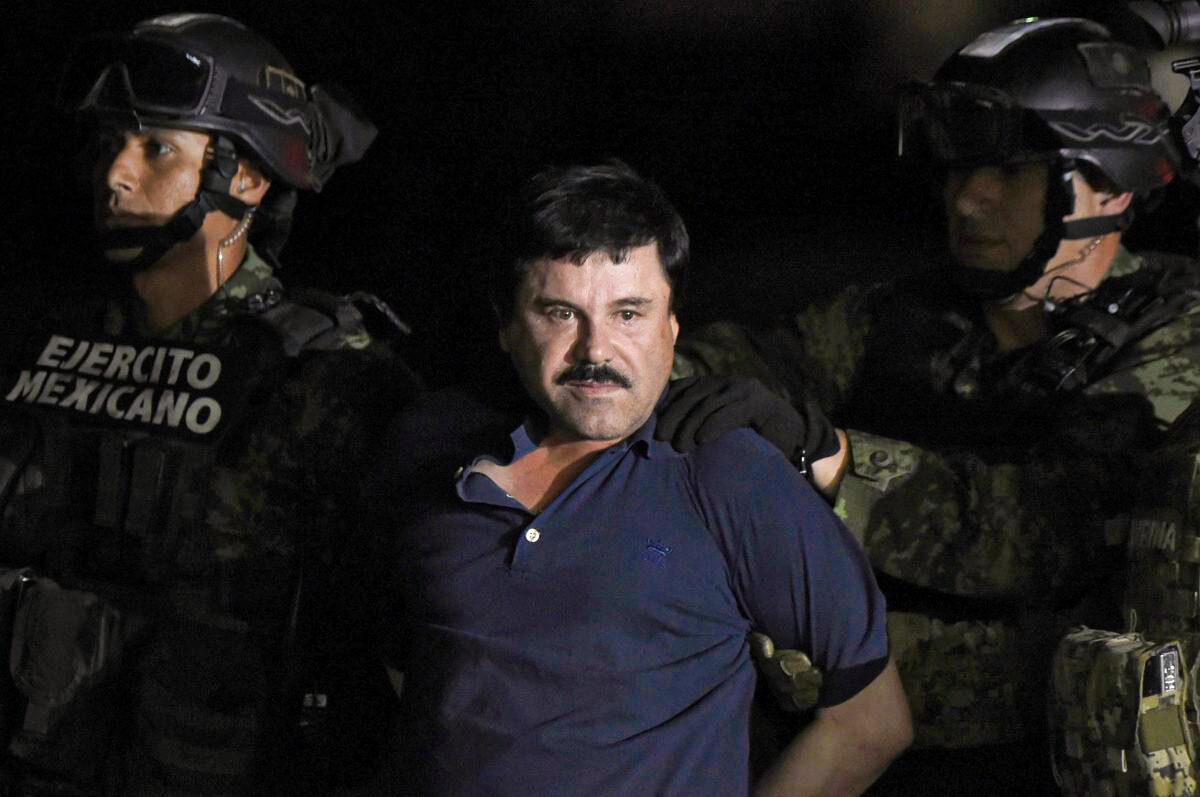 Drug kingpin Joaquin "El Chapo" Guzman is escorted into a helicopter at Mexico City's airport on Jan. 8, 2016. (Alfredo Estrella/AFP/Getty Images)