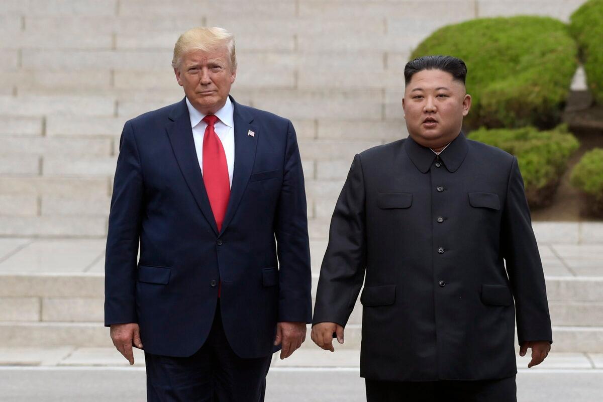 U.S. President Donald Trump (L) meets with North Korean leader Kim Jong Un (R) at the North Korean side of the border at the village of Panmunjom in the Demilitarized Zone, on June 30, 2019. (Susan Walsh/AP)