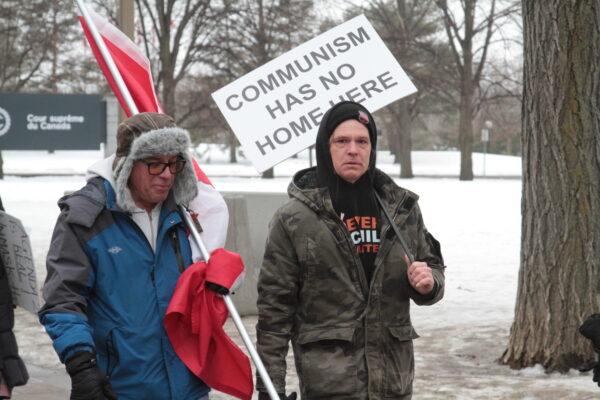 A protester makes his view known on a placard on Feb. 11, 2022. (Richard Moore/The Epoch Times)