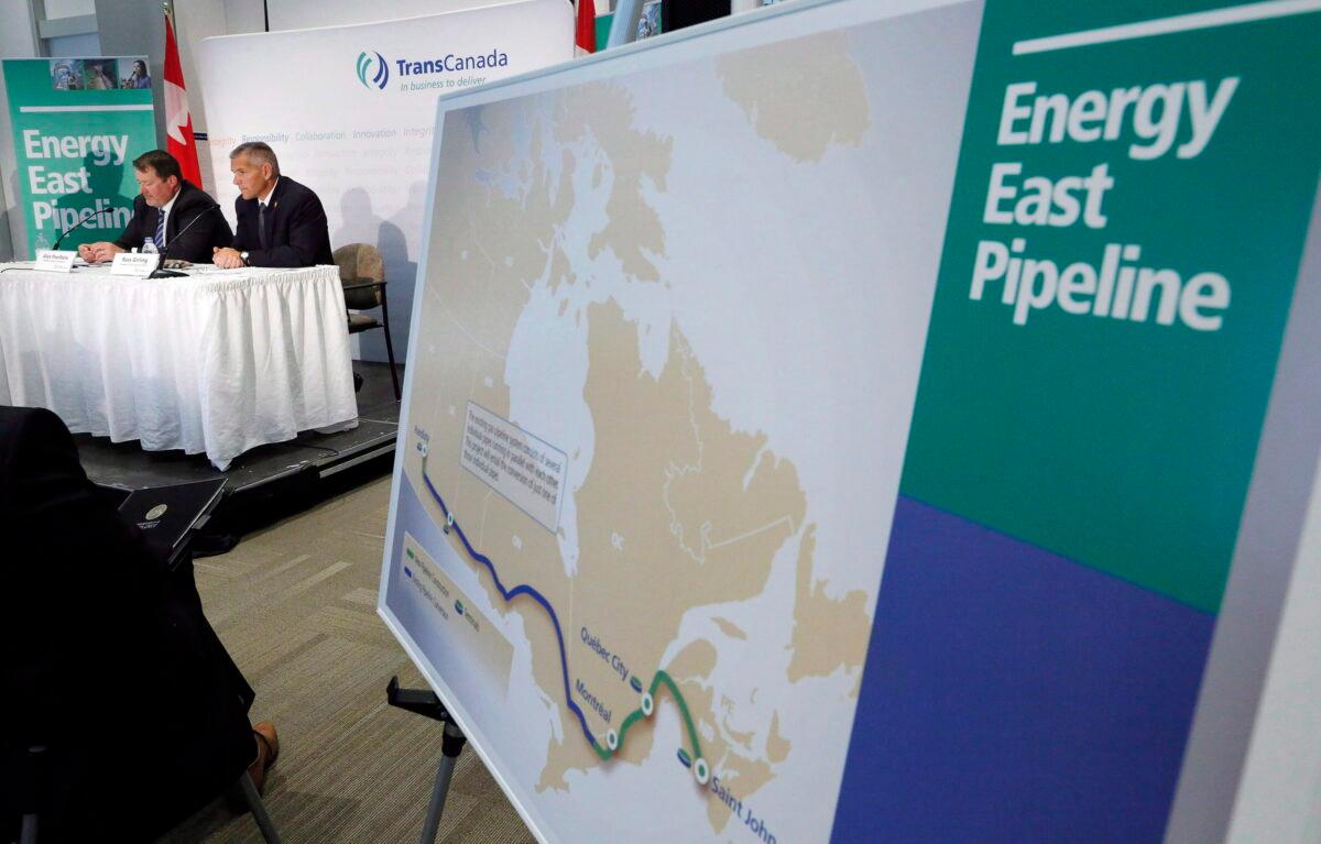 The now-cancelled Energy East pipeline’s proposed route is displayed during a news conference in Calgary on Aug. 1, 2013. (The Canadian Press/Jeff McIntosh)
