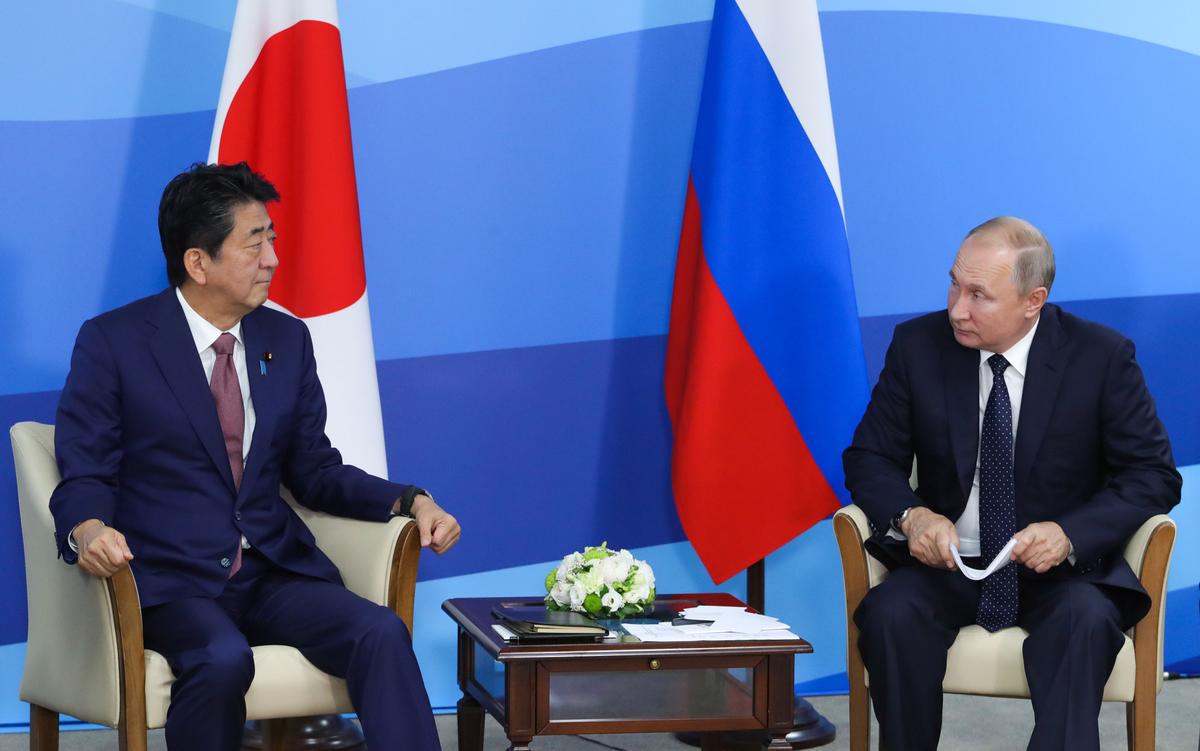 Japan's Prime Minister Shinzo Abe (L) speaks with Russian President Vladimir Putin during a meeting in Vladivostok on Sept. 5, 2019. (Mikhail Klimentyev/Sputnik/AFP via Getty Images)
