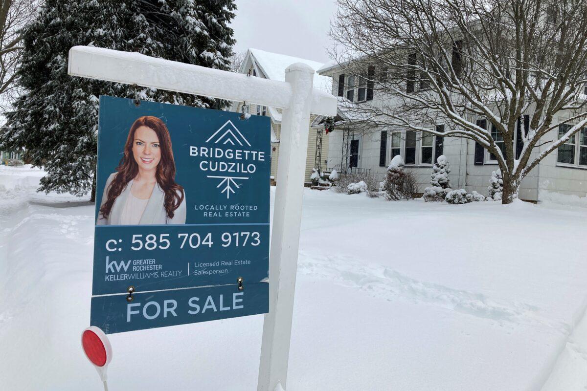 A "for sale" sign stands in front of a house in Rochester, N.Y., on Jan. 17, 2022. (Ted Shaffrey/AP Photo)