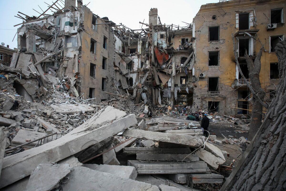Rescue workers examine a damaged portion at the site of a suicide bombing after authorities finished the rescue operation in Peshawar, Pakistan, on Jan. 31, 2023. (Muhammad Sajjad/AP Photo)