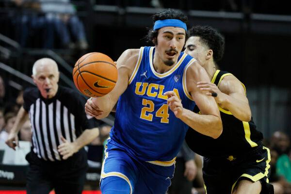 Jaime Jaquez Jr. (24) of the UCLA Bruins dribbles the ball against Will Richardson (0) of the Oregon Ducks during the second half at Matthew Knight Arena in Eugene, Ore., on Feb. 11, 2023. (Soobum Im/Getty Images)