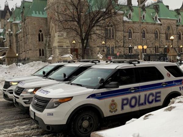Police vehicles in downtown Ottawa as protesters mark the one-year anniversary of police removal of the Freedom Convoy on Feb. 18, 2023. (Jonathan Ren/The Epoch Times)
