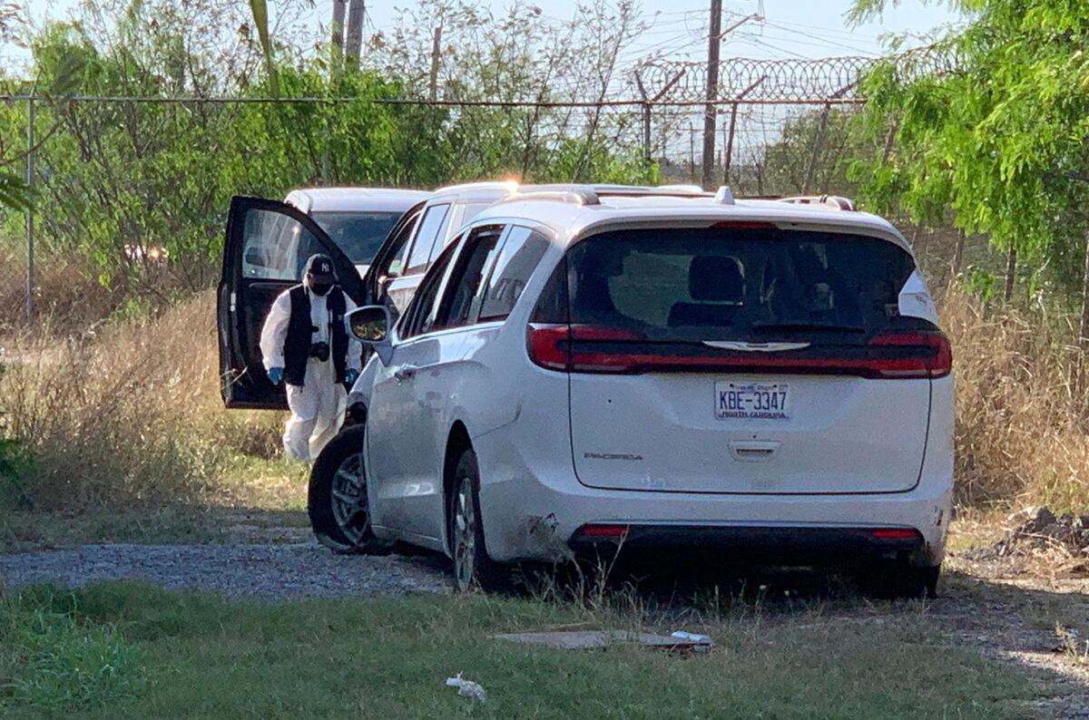 A Mexican police investigator inspects the minivan where four Americans were shot and taken at the Tamaulipas State Prosecutor´s headquarters in Matamoros, Mexico, on March 8, 2023. (AP Photo)