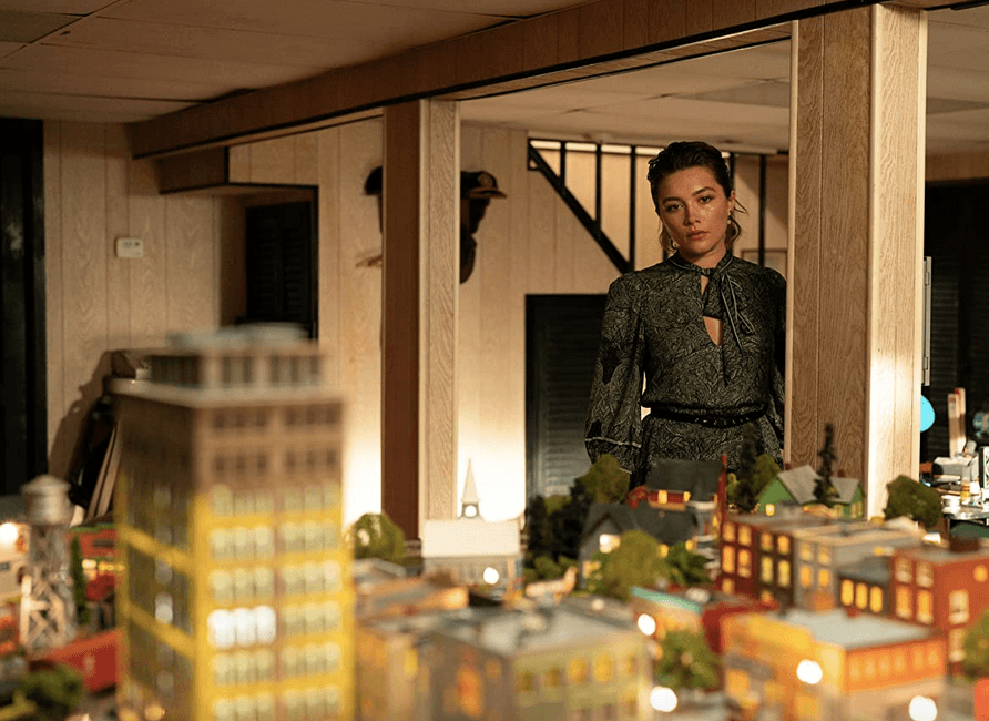 Allison (Florence Pugh) studies Daniel's basement model train setup, in "A Good Person." (United Artists)