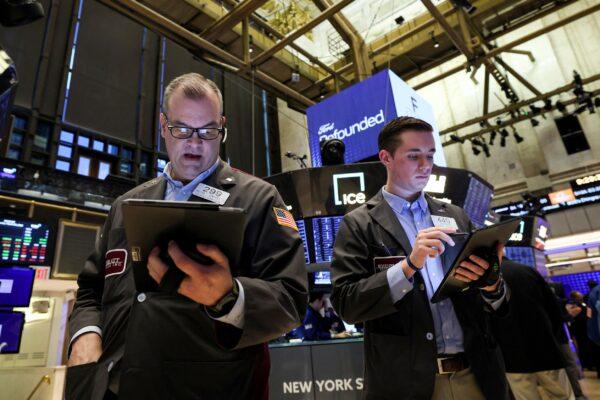Traders work on the floor of the New York Stock Exchange (NYSE) in New York City on March 23, 2023. (Brendan McDermid/Reuters)
