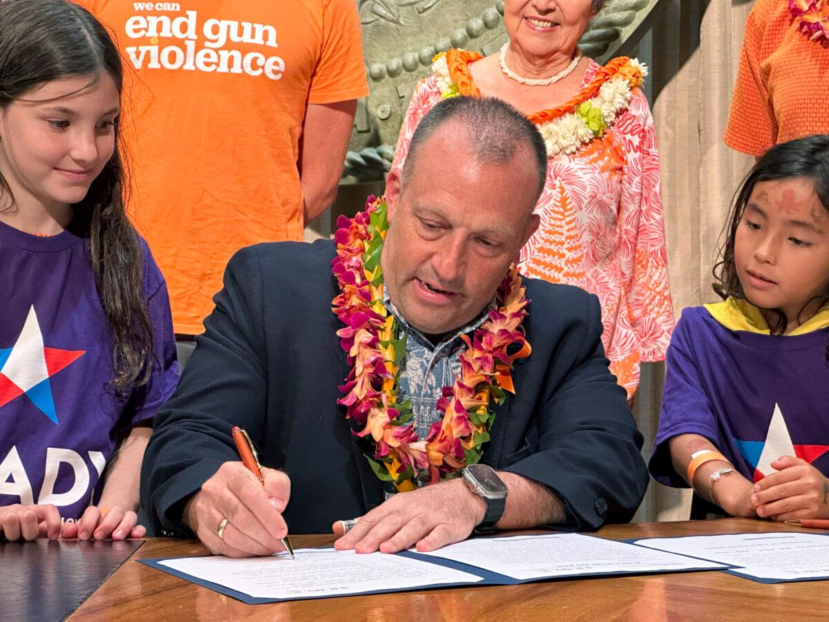 Hawaii Gov. Josh Green signs gun control legislation in Honolulu on June 2, 2023. (Audrey McAvoy/AP Photo)