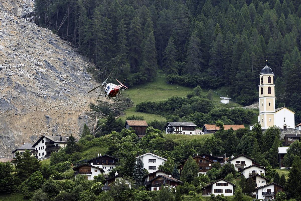 Mass of Rock Slides Down Swiss Mountainside Above Evacuated Village, Narrowly Missing Settlement
