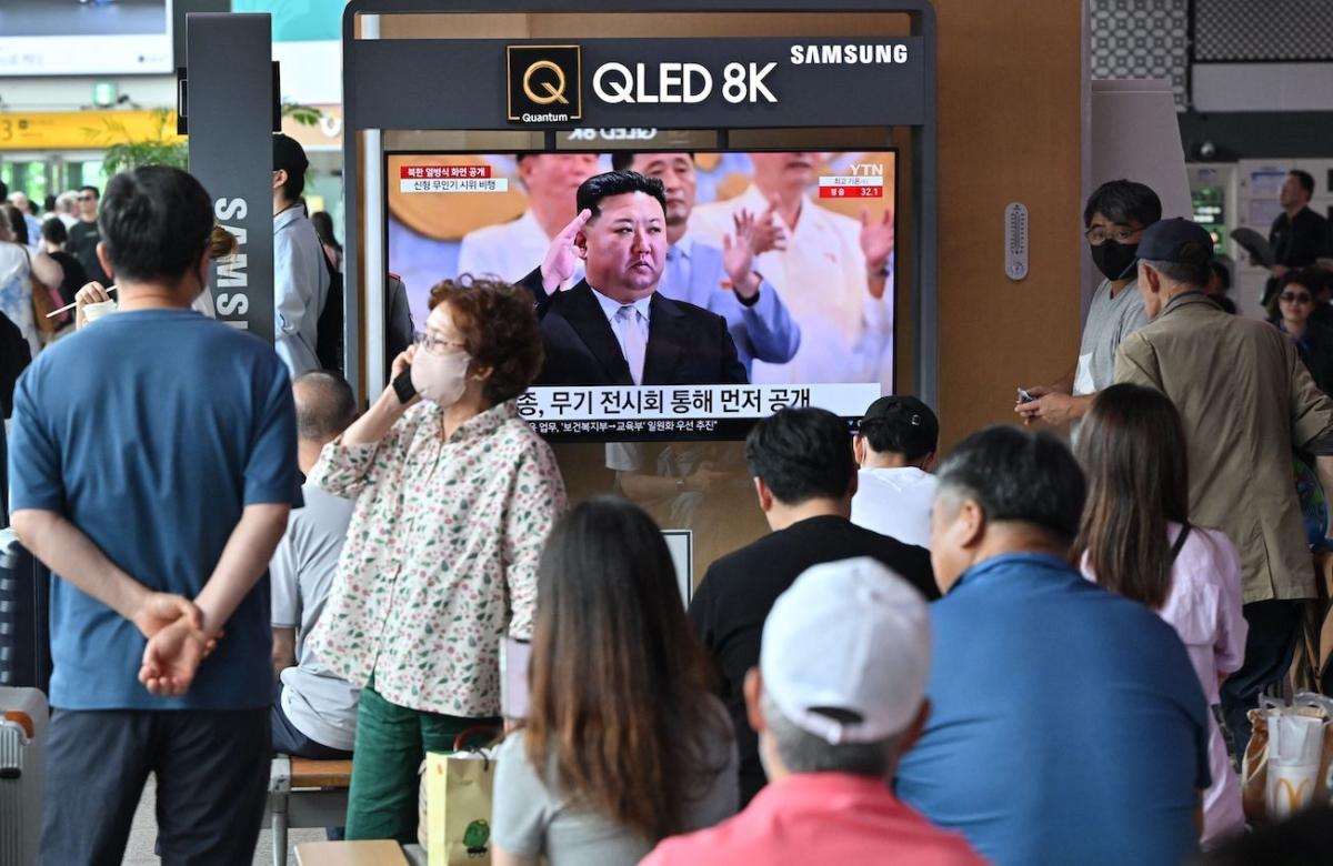 People watch a television screen showing a news broadcast with an image of North Korean leader Kim Jong Un attending a military parade held in Pyongyang to mark the 70th anniversary of the Korean War armistice, at a railway station in Seoul on July 28, 2023. (Jung Yeon-Je/AFP via Getty Images)