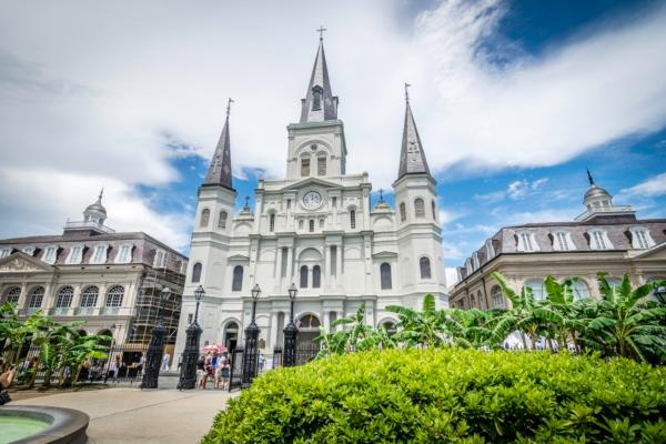 St. Louis Cathedral’s triple-spire façade has made it widely recognizable, not only in New Orleans but throughout the South and the nation. There's symmetry in the two outward spires with star-topped cross adornments, balanced columns and arched windows, and dominant spire as the center point. In 1819, a clock tower—originally backlit by gas—was added; the current front-view clock is a replica of the original early-19th-century clock. (Courtesy of the Archdiocese of New Orleans)