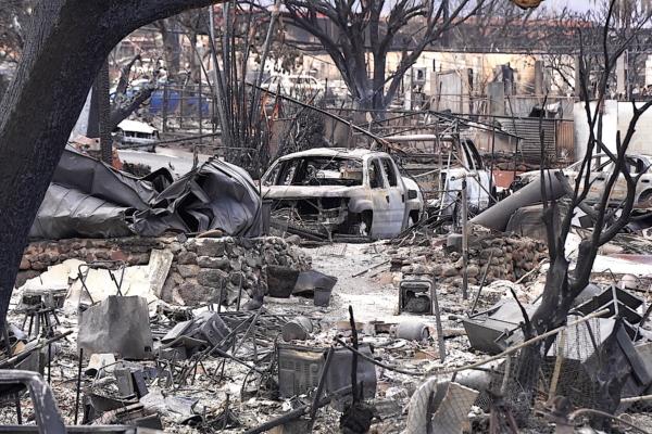 The charred remains of homes and parked vehicles was visible from the now reopened Route 30 in Lahaina in West Maui one Aug. 16, 2023. (Allan Stein/The Epoch Times)