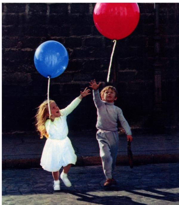 A little girl (Sabine Lamorisse) with a blue balloon and a little boy (Pascal Lamorisse) with a red balloon, in “The Red Balloon." (Films Montsouris)