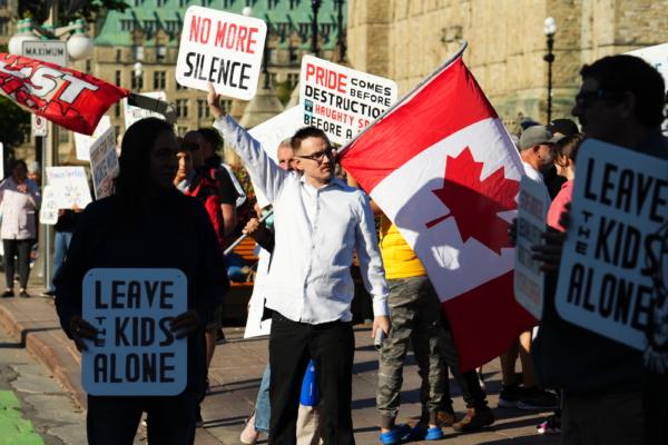 People hold signs during the 1 Million March for Children demonstration supporting parental rights, in Ottawa on Sept. 20, 2023. (The Canadian Press/Sean Kilpatrick)