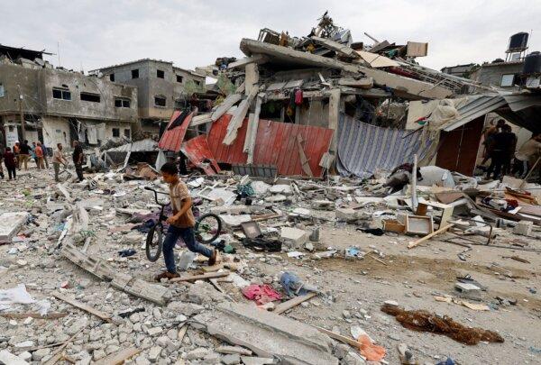 A child walks at the site of an Israeli air strike on a house, in Khan Younis in the southern Gaza Strip, on Oct. 27, 2023. (Mohammed Salem/Reuters)