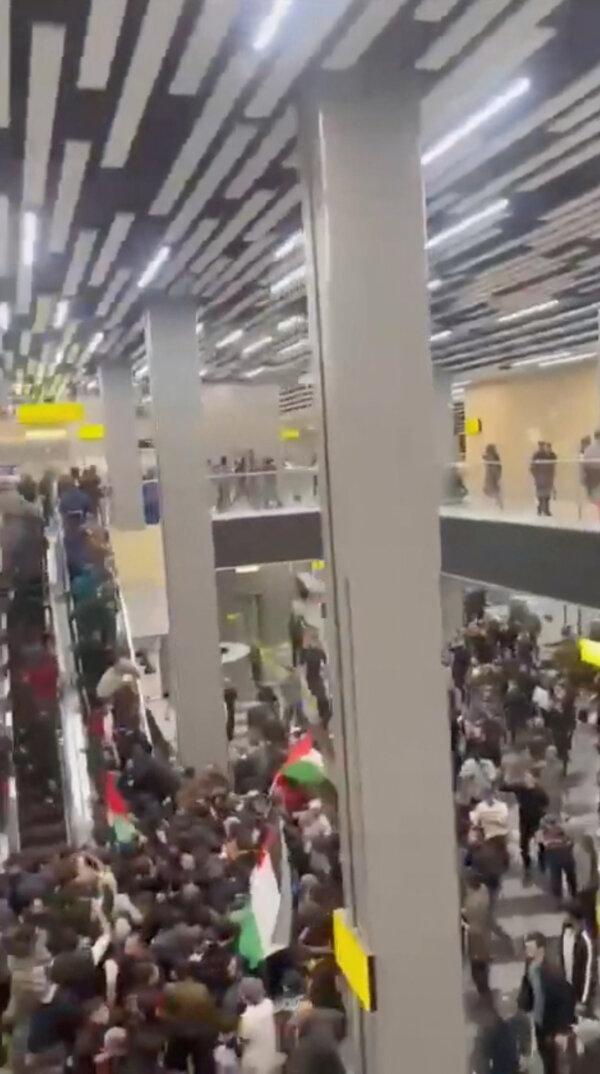 Pro-Palestinian protesters storm an airport building in Makhachkala, Russia, on Oct. 29, 2023, in this screenshot taken from video footage obtained by Reuters. (Video obtained by Reuters/via Reuters)