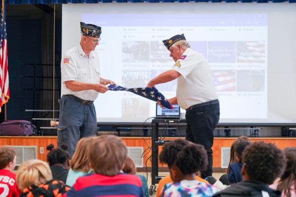 A flag folding demonstration during a patriotism program by the American Legion Post 1181 at Circleville Elementary School in Circleville, N.Y., on Nov. 6, 2023. (Cara Ding/The Epoch Times)