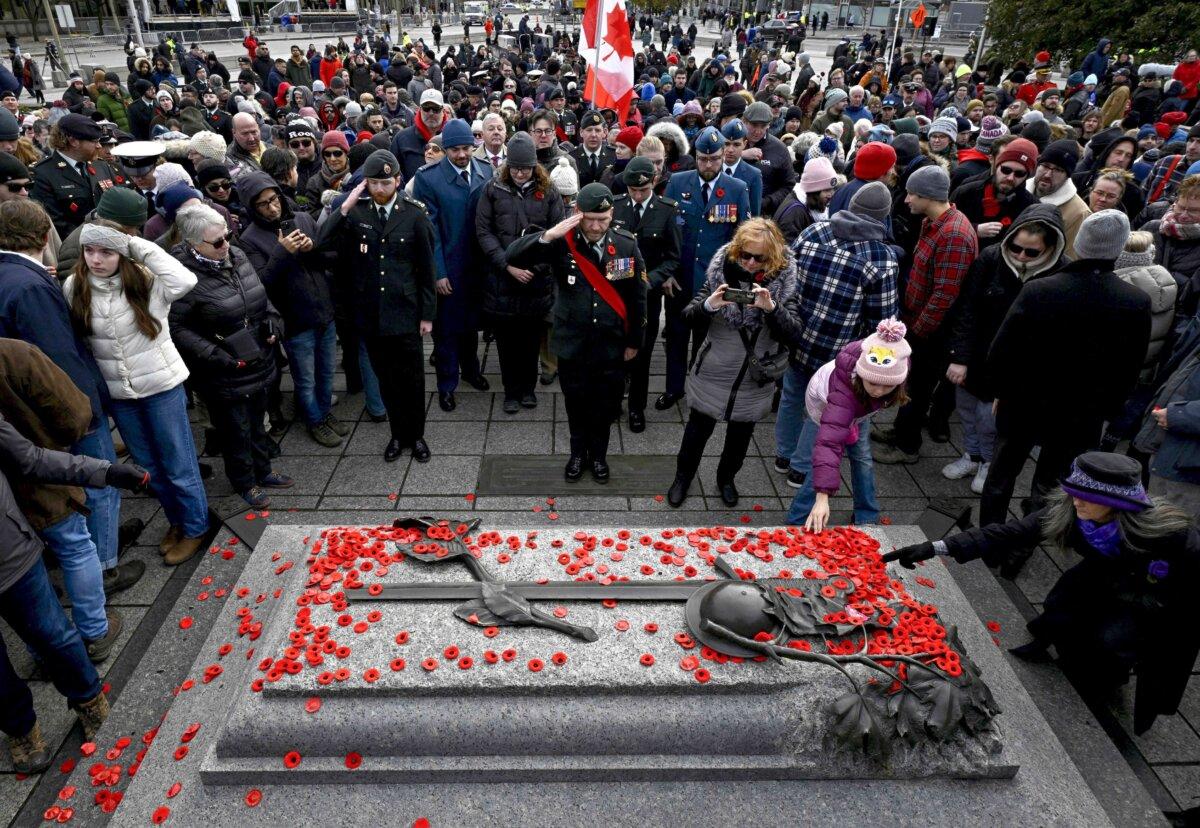 Canadian Armed Forces members salute after the Remembrance Day Ceremony at the National War Memorial in Ottawa on Nov. 11, 2023. (The Canadian Press/Justin Tang)