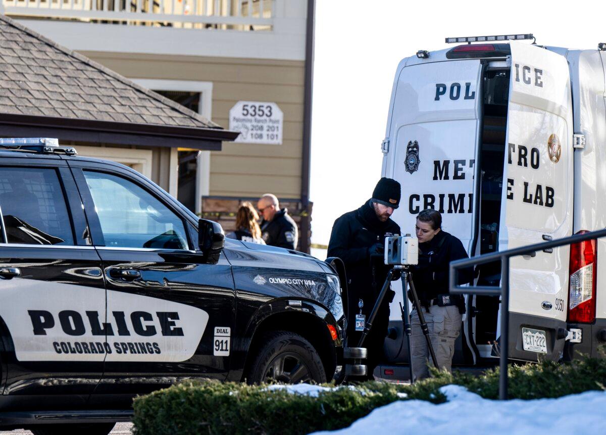 Colorado Springs Police Department investigators and officers respond to a 911 call reporting a burglary where they found children dead inside a condo of the Palomino Ranch Point complex in Colorado Springs, Colo., on Dec. 19, 2023. (Parker Seibold/The Gazette via AP)