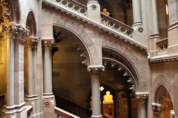 The staircase to the Assembly Chamber is made of Dorchester sandstone from New Brunswick, Canada, and was designed by Leopold Eidlitz. This part of the Capitol presents half arches with bas-relief animal carvings, polished columns, and quatrefoil cutouts as part of the arch and banister designs. Moorish-style cutouts along the staircase enable anyone traveling up or down the stairs to view other areas of the Capitol. (New York State Office of General Services)