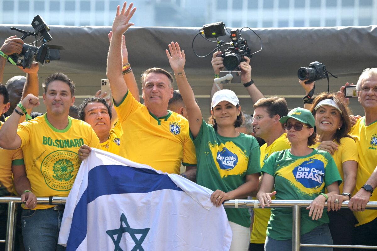 Former Brazilian President Jair Bolsonaro (2nd L) greets supporters next to his wife Michelle Bolsonaro during a rally in Sao Paulo, Brazil, on Feb. 25, 2024. (Nelson Almeida/AFP via Getty Images)