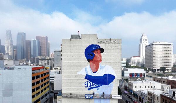Muralist Robert Vargas (C) and others work on a new Shohei Ohtani mural titled "L.A. Rising," on the Miyako Hotel in the Little Tokyo area of Los Angeles on March 20, 2024. (Dean Musgrove/The Orange County Register via AP)