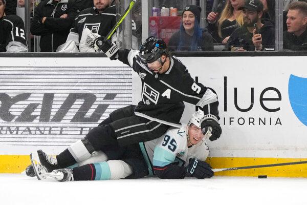 Adrian Kempe of the Los Angeles Kings falls on top of the Seattle Kraken's Andre Burakovsky during an NHL game in Los Angeles on April 3, 2024. (Mark J. Terrill/AP Photo)