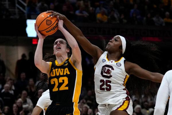 Raven Johnson of South Carolina blocks a shot by Iowa's Caitlin Clark during the women's NCAA Tournament championship game in Cleveland on April 7, 2024. (Carolyn Kaster/AP Photo)