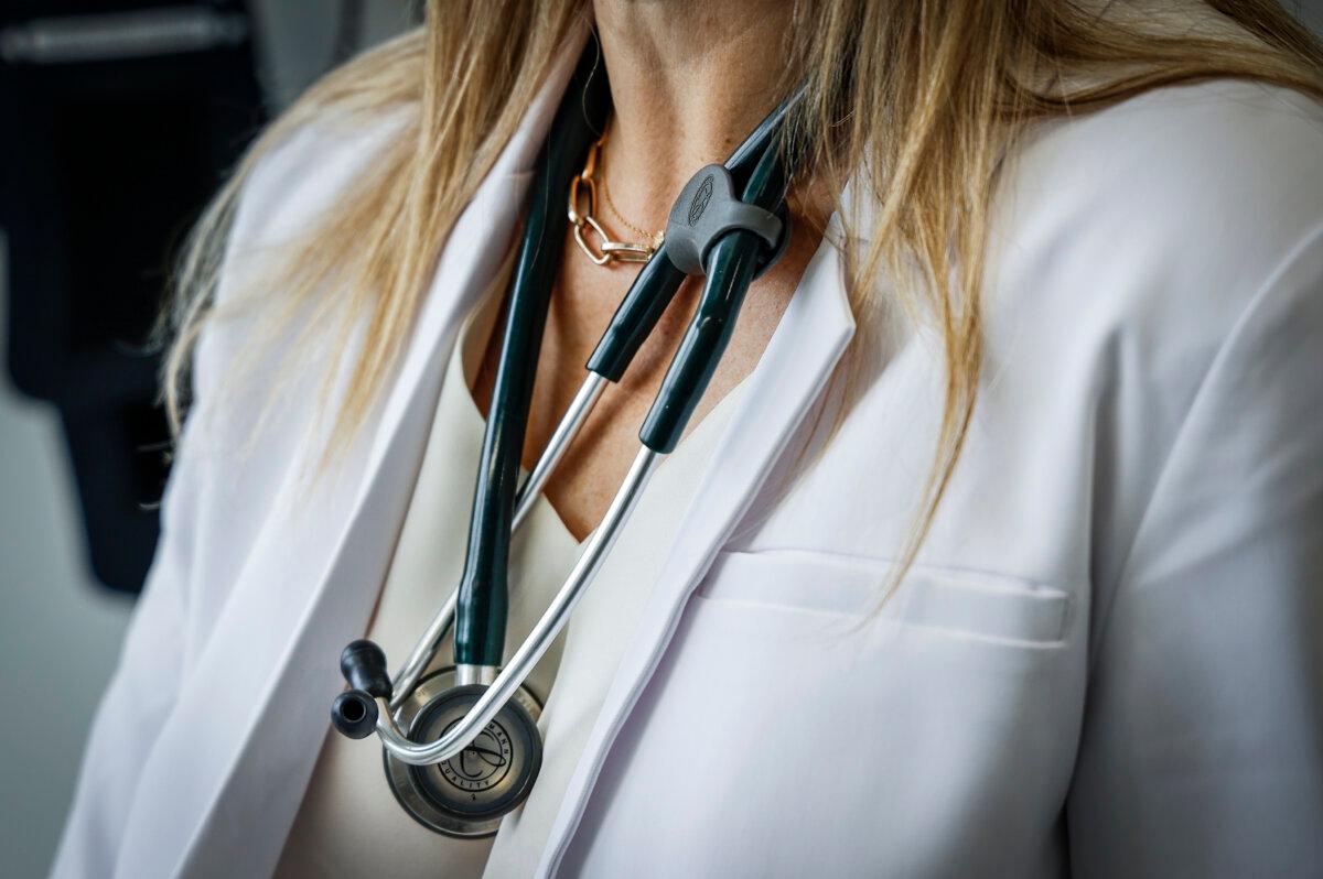 A doctor in an exam room at a health clinic in Calgary on July 14, 2023. (The Canadian Press/Jeff McIntosh)