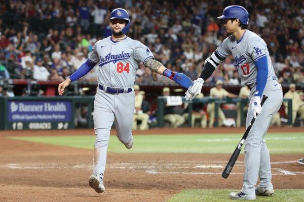 Andy Pages (84) of the Los Angeles Dodgers high fives Shohei Ohtani (17) after scoring a run on a wild pitch during the fifth inning of the MLB game in Phoenix on April 30, 2024. (Christian Petersen/Getty Images)