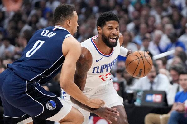 Paul George of the Clippers tries to drive past the Mavericks' Dante Exum during an NBA playoff game in Los Angeles on May 1, 2024. (Mark J. Terrill/AP Photo)