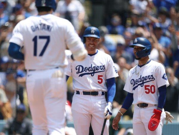 Mookie Betts (50) and Freddie Freeman (5) of the Los Angeles Dodgers react to a two run home run from Shohei Ohtani (17), to take a 2–0 lead over the Atlanta Braves during the first inning in Los Angeles on May 5, 2024. (Harry How/Getty Images)