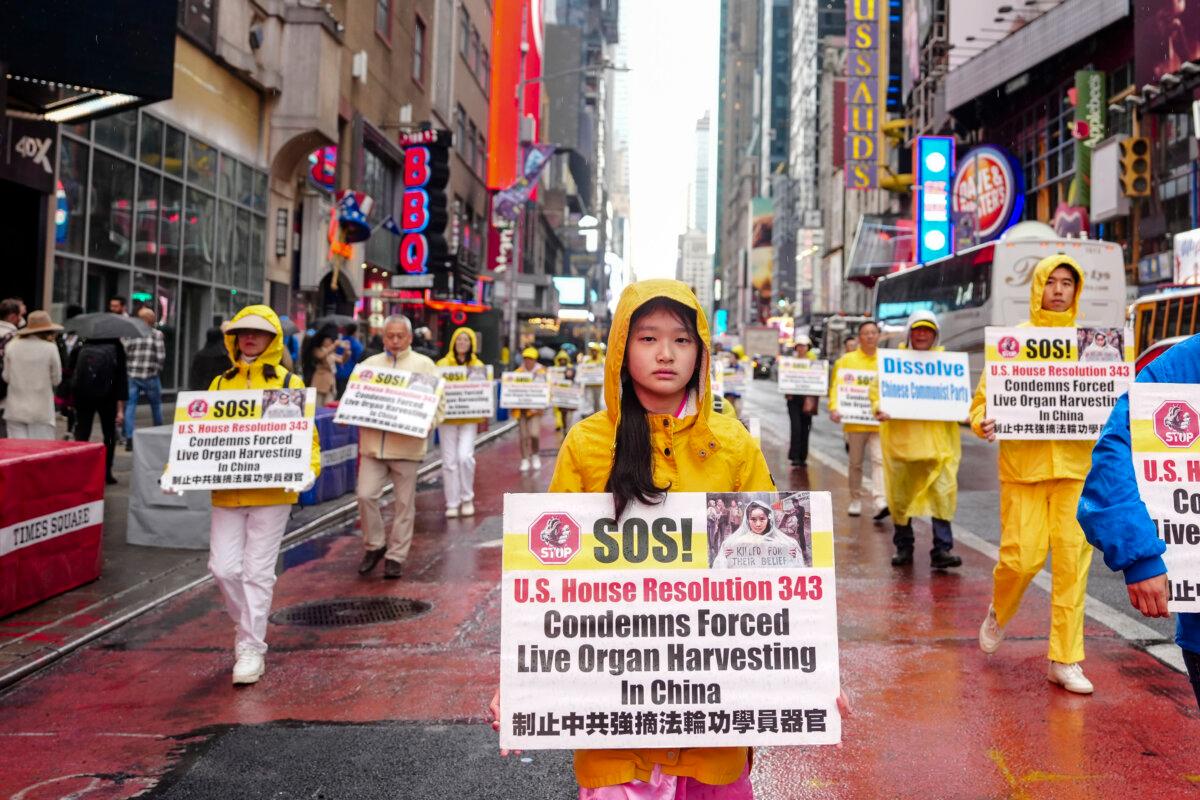 Falun Gong practitioners take part in a parade to celebrate World Falun Dafa Day while calling for an end of the persecution in China, in New York City, on May 10, 2024. (Samira Bouaou/The Epoch Times)