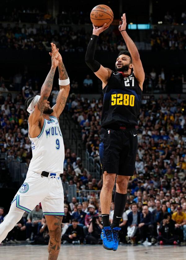 Jamal Murray of the Nuggets shoots over the Timberwolves' Nickeil Alexander-Walker in Game 7 of an NBA playoff series in Denver on May 19, 2024. (David Zalubowski/AP Photo)