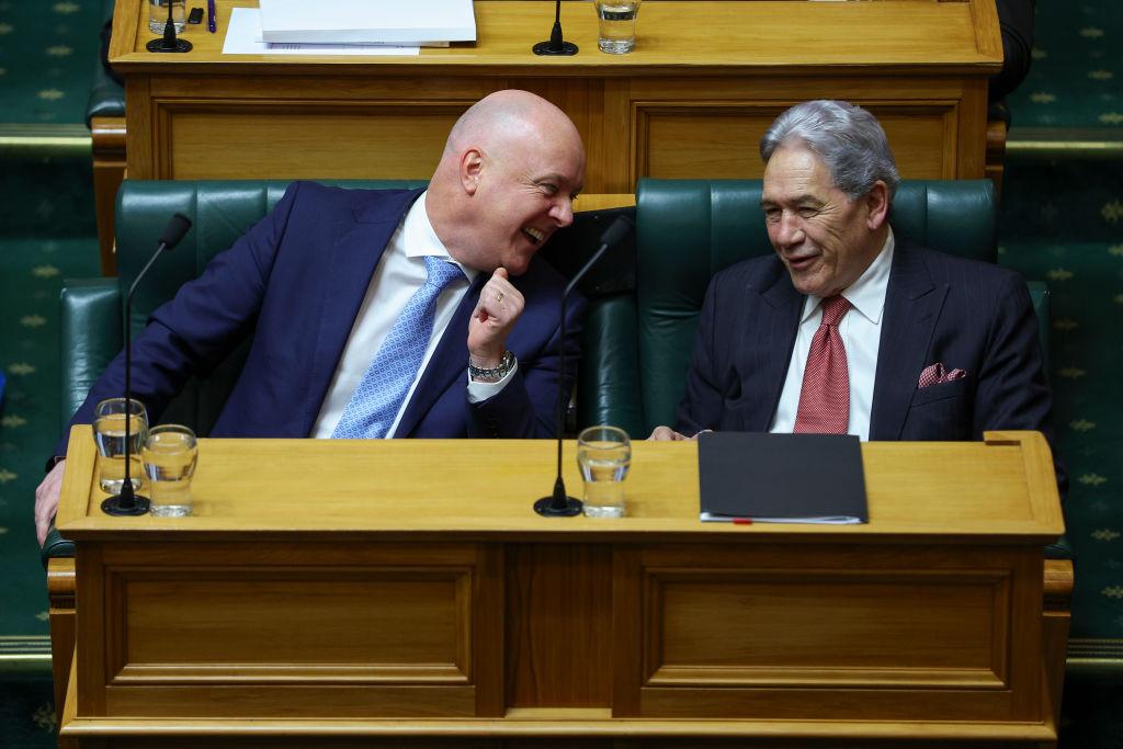 Prime Minister Christopher Luxon speaks to Deputy Prime Minister and NZ First Leader Winston Peters during budget day 2024 at Parliament in Wellington, New Zealand on May 30, 2024. (Hagen Hopkins/Getty Images)