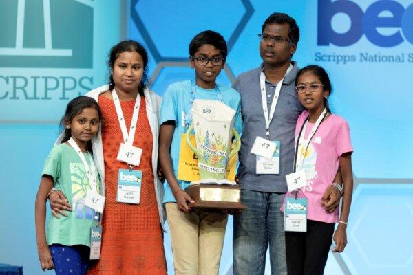 Bruhat Soma, 12, of Tampa, Fla., stands on stage with his family after winning the Scripps National Spelling Bee, in Oxon Hill, Md., on May 30, 2024. (Mariam Zuhaib/AP Photo)