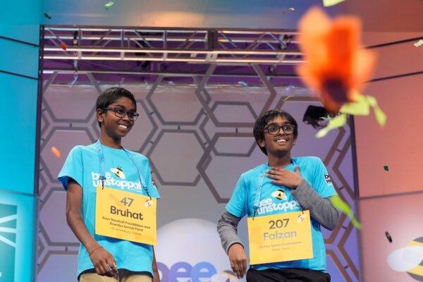 As confetti falls Bruhat Soma, 12, of Tampa, Fla., left, smiles after winning the Scripps National Spelling Bee, in Oxon Hill, Md., on May 30, 2024, as Faizan Zaki, 12, of Allen, Texas, stands next to him on stage. (Jacquelyn Martin/AP Photo)