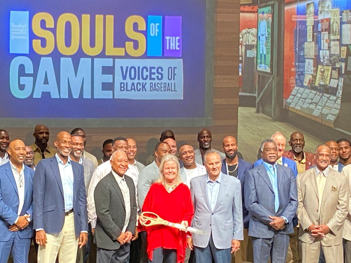 Joe Torre (L-3) and Hall of Fame Chairman of the Board Jane Forbes Clark (L-4), posed for photos at the ribbon-cutting ceremony of the Hall of Fame's newest exhibit: The Souls of the Game: Voices of Black Baseball, in Cooperstown, New York, on May 25, 2024. (Donald Laible/The Epoch Times)